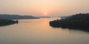 Tranquil lake at sunrise, promoting calmness and relaxation.